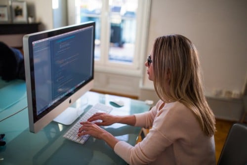 woman working at a computer using slack workspaces with a virtual assistant