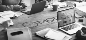 myoutdesk virtual assistants working together at a table on laptops